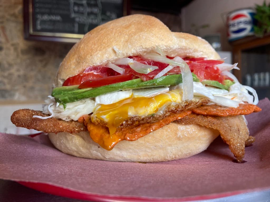 Torta abundante con milanesa, aguacate y huevo de Cosme Tortas